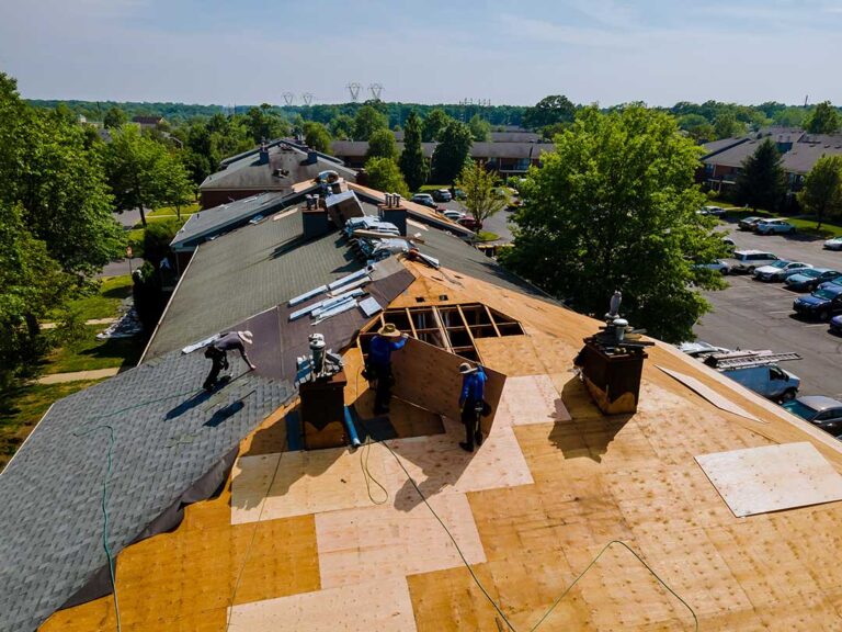 A residential home showing distinct roof slopes, dormer windows, eaves, and a cleanly designed attic level.